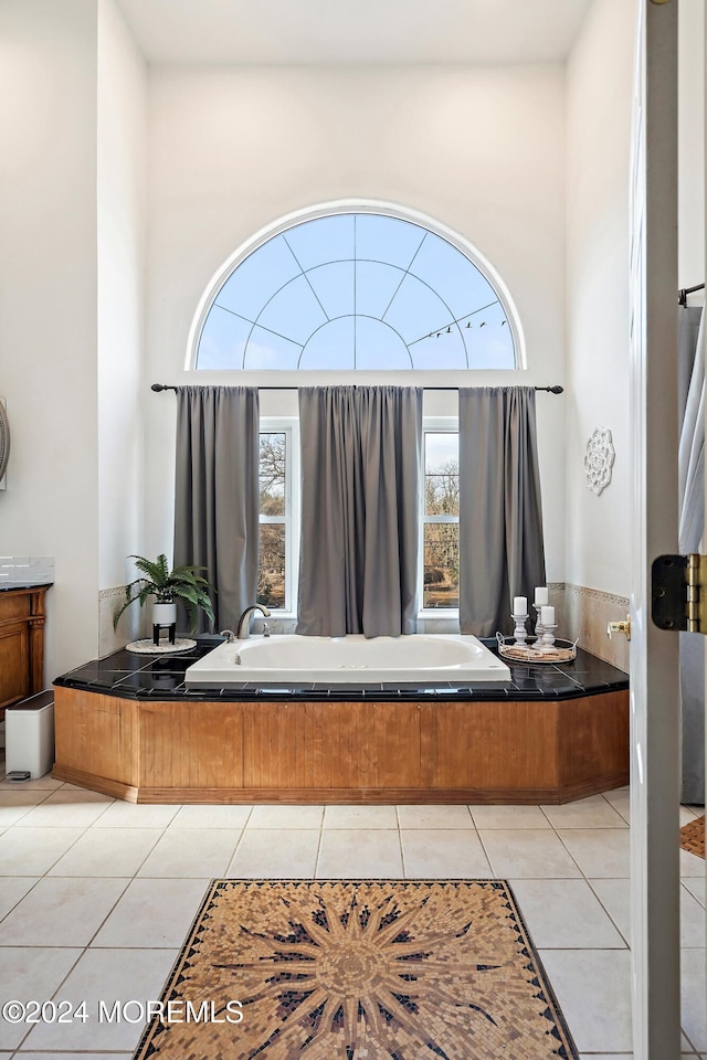 bathroom featuring tile patterned floors, a bathtub, and vanity