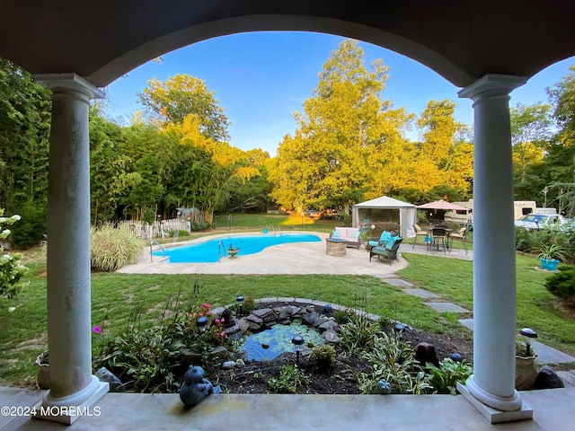 view of swimming pool with a lawn and a patio