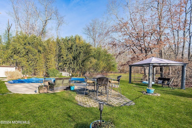 view of yard featuring a gazebo, a patio, and a covered pool