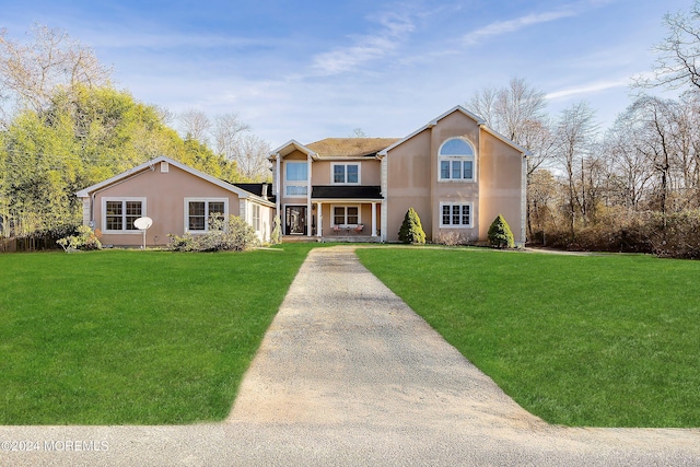 view of front facade featuring a front lawn and a porch