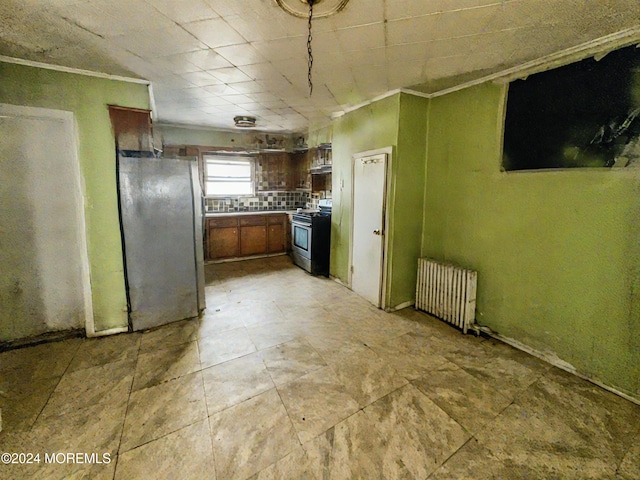 kitchen with backsplash, radiator heating unit, stainless steel appliances, and ornamental molding