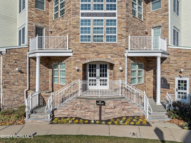 exterior space featuring a balcony and french doors