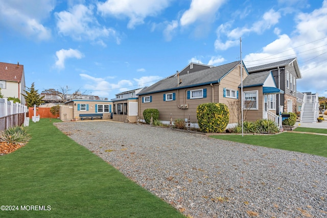 back of house with a lawn