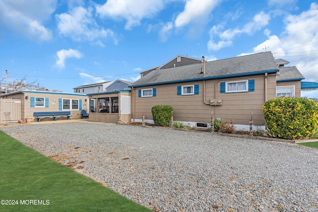 rear view of house featuring a sunroom