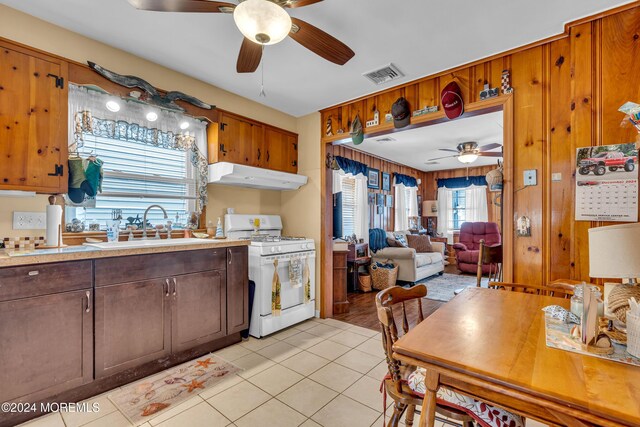 228 Hancock Ave, Seaside Heights, NJ 08751 - kitchen with white range with gas cooktop, under cabinet range hood, a ceiling fan, a sink, and light countertops