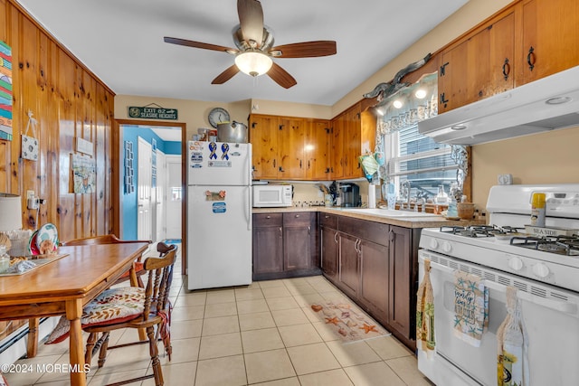 228 Hancock Ave, Seaside Heights, NJ 08751 - kitchen with white appliances, ceiling fan, under cabinet range hood, light tile patterned floors, and a sink