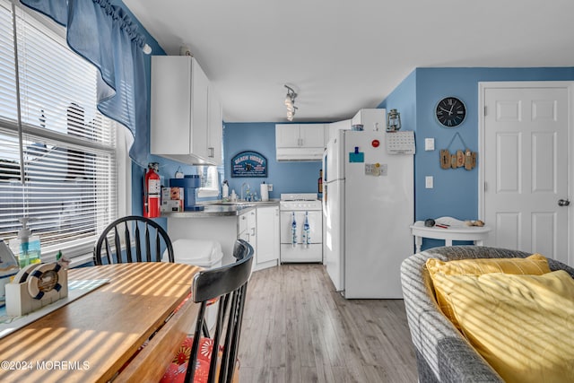 kitchen with white cabinetry, white appliances, and light wood-type flooring