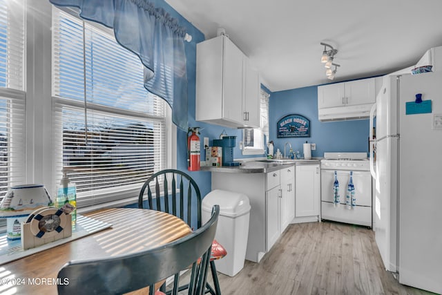 kitchen featuring white appliances, light hardwood / wood-style flooring, white cabinetry, and sink