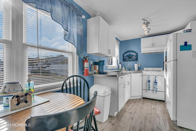 228 Hancock Ave, Seaside Heights, NJ 08751 - kitchen featuring white appliances, under cabinet range hood, light wood-type flooring, and white cabinetry