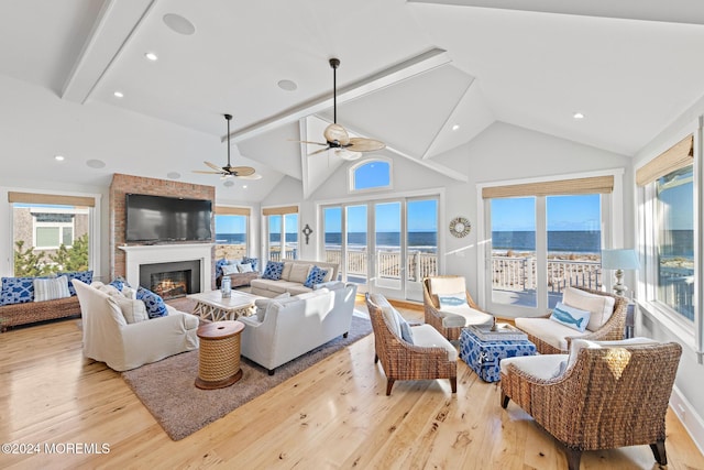 living room featuring beam ceiling, ceiling fan, high vaulted ceiling, and light hardwood / wood-style floors