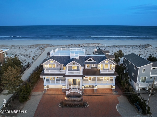 exterior space featuring a water view and a view of the beach