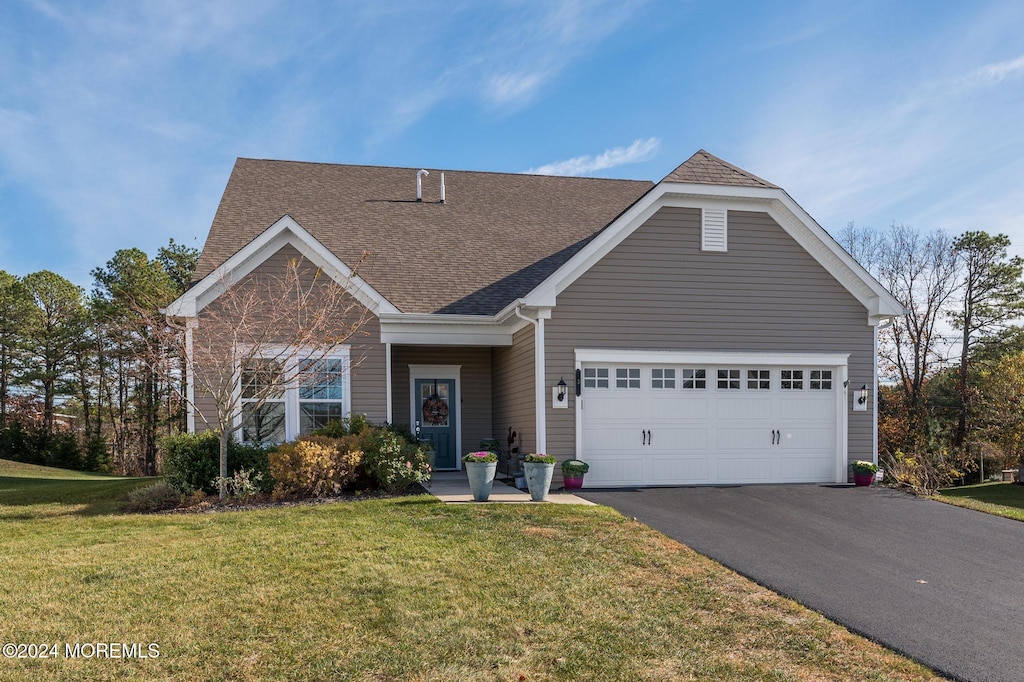 view of front facade with a garage and a front yard