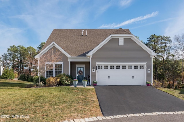 view of front of property with a front lawn and a garage