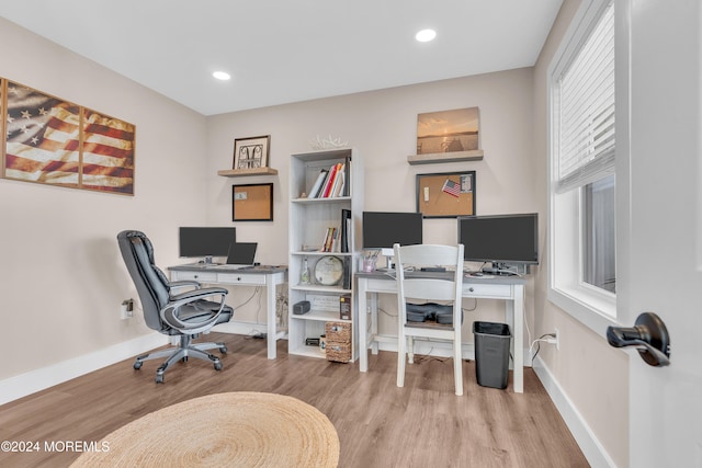 office area with light hardwood / wood-style floors