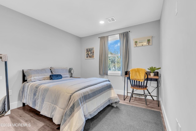 bedroom with hardwood / wood-style flooring