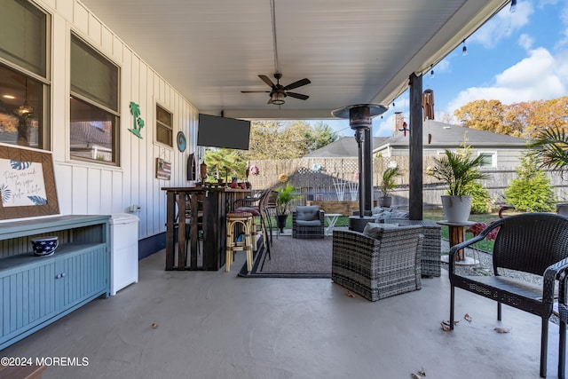 view of patio featuring ceiling fan, an outdoor living space, and an outdoor bar