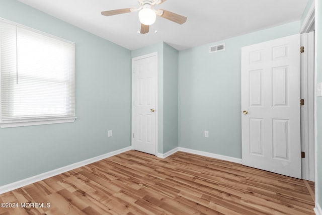 unfurnished bedroom with ceiling fan and light hardwood / wood-style flooring