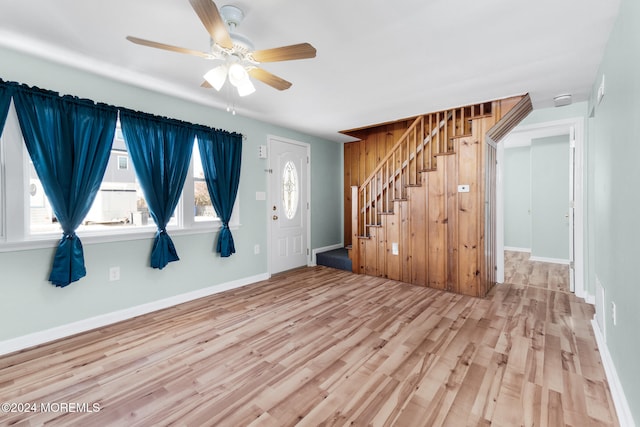 foyer entrance with hardwood / wood-style flooring and ceiling fan