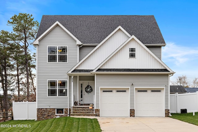 craftsman-style home with a front lawn and a garage