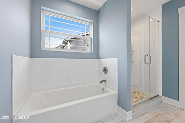 bathroom featuring shower with separate bathtub