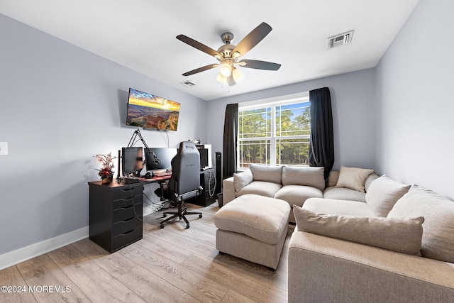 home office featuring ceiling fan and light hardwood / wood-style flooring