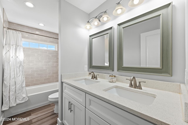 full bathroom with vanity, wood-type flooring, shower / bath combo, and toilet