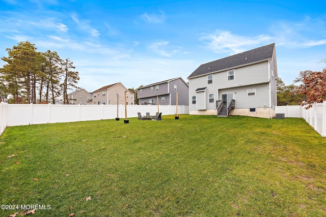 exterior space with a lawn and central AC unit