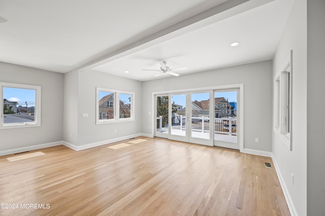 empty room with ceiling fan and light wood-type flooring