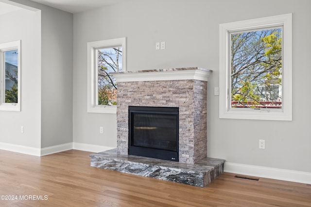 unfurnished living room featuring light hardwood / wood-style floors and a fireplace