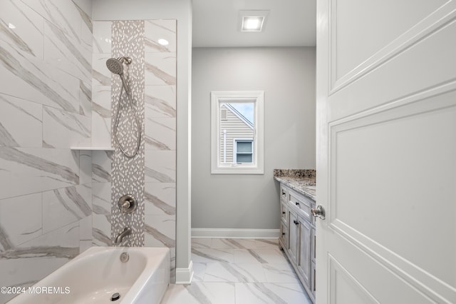 bathroom featuring vanity and tiled shower / bath