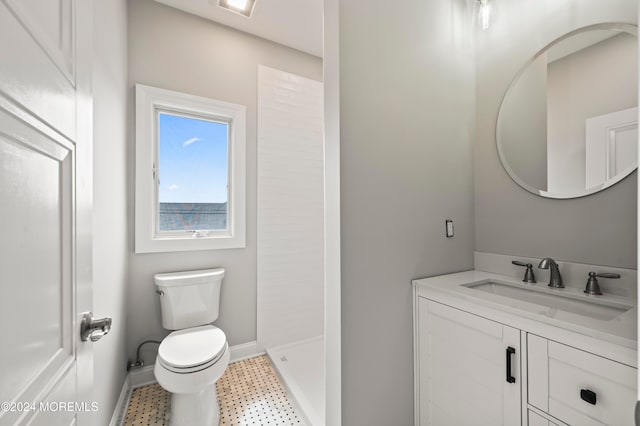 bathroom featuring tile patterned floors, a shower, vanity, and toilet