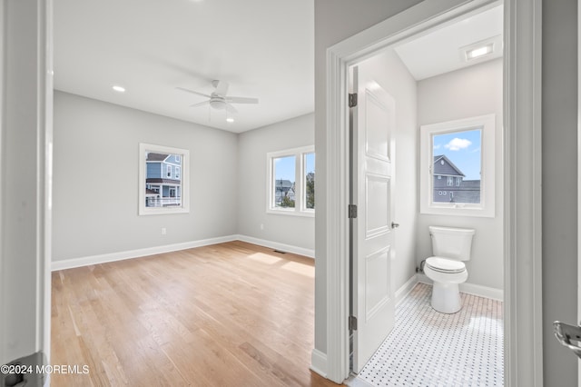 bathroom featuring hardwood / wood-style floors, ceiling fan, and toilet