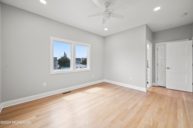 empty room featuring ceiling fan and light wood-type flooring