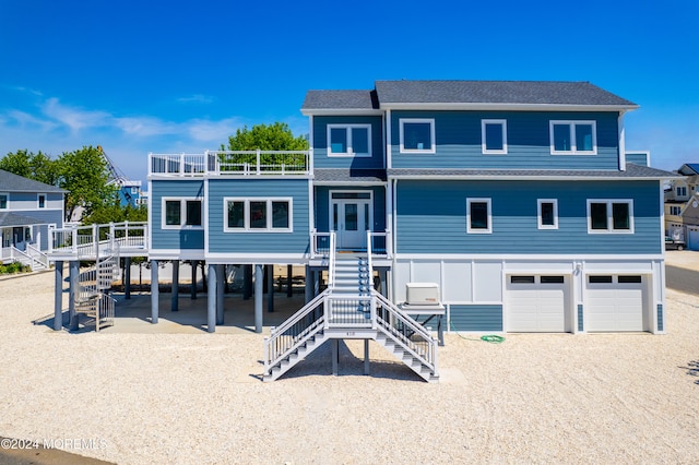 view of front of house featuring a carport, a garage, and a balcony