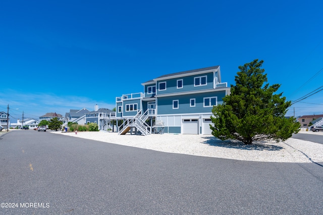 raised beach house featuring a garage