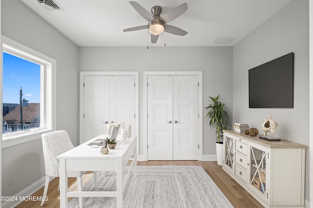 home office with ceiling fan and hardwood / wood-style floors