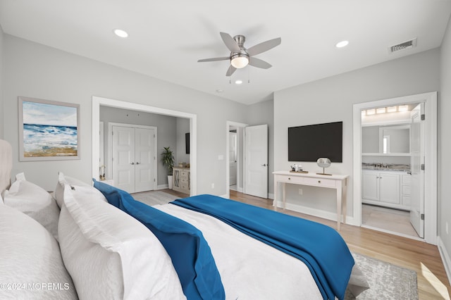 bedroom with ensuite bath, ceiling fan, and light wood-type flooring