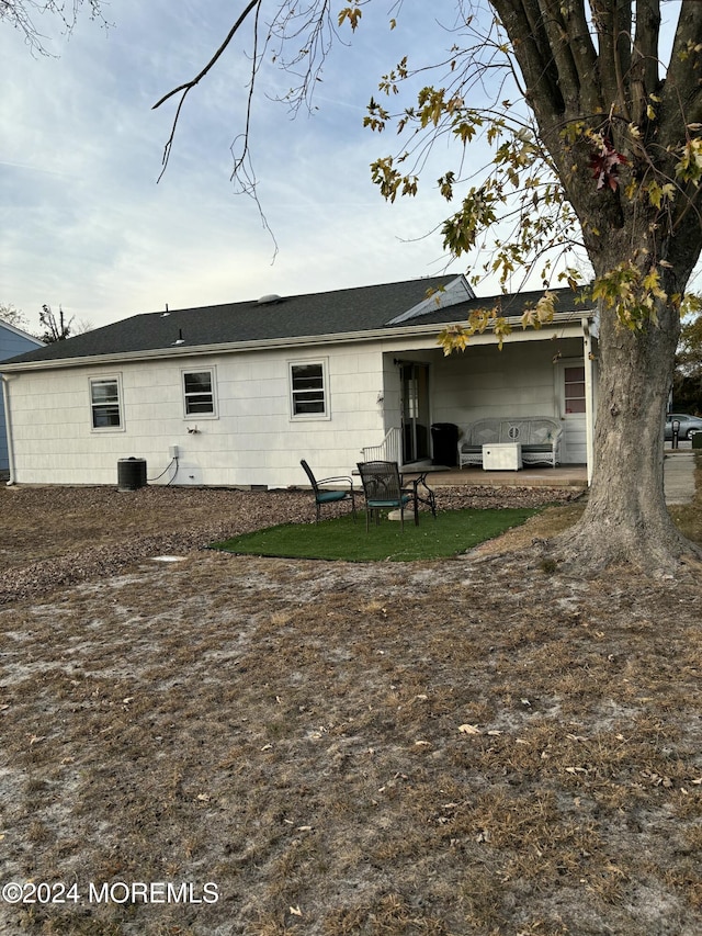 back of house with a patio area and central AC unit