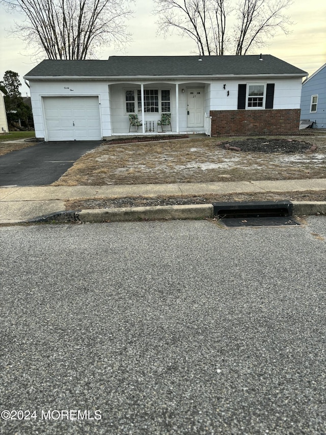 view of front of property with a porch and a garage