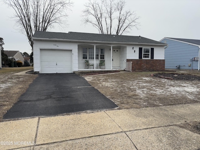 single story home with a garage and covered porch