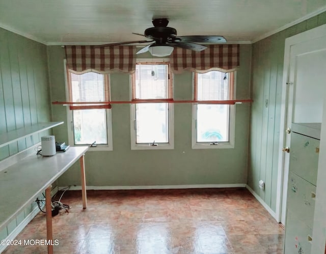 unfurnished office featuring ceiling fan and ornamental molding