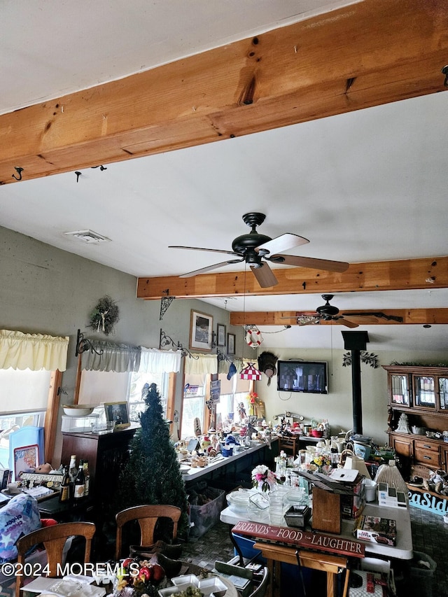 miscellaneous room featuring ceiling fan and a wood stove