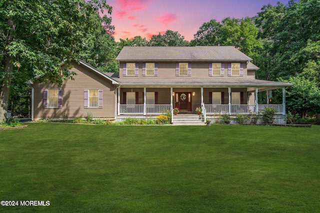 view of front of house with a lawn and covered porch