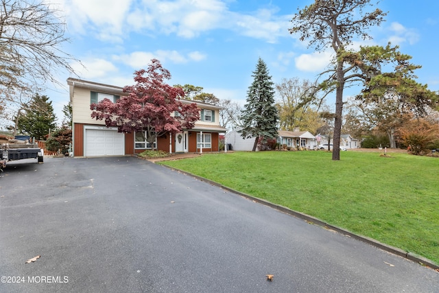 view of front facade featuring a front yard and a garage