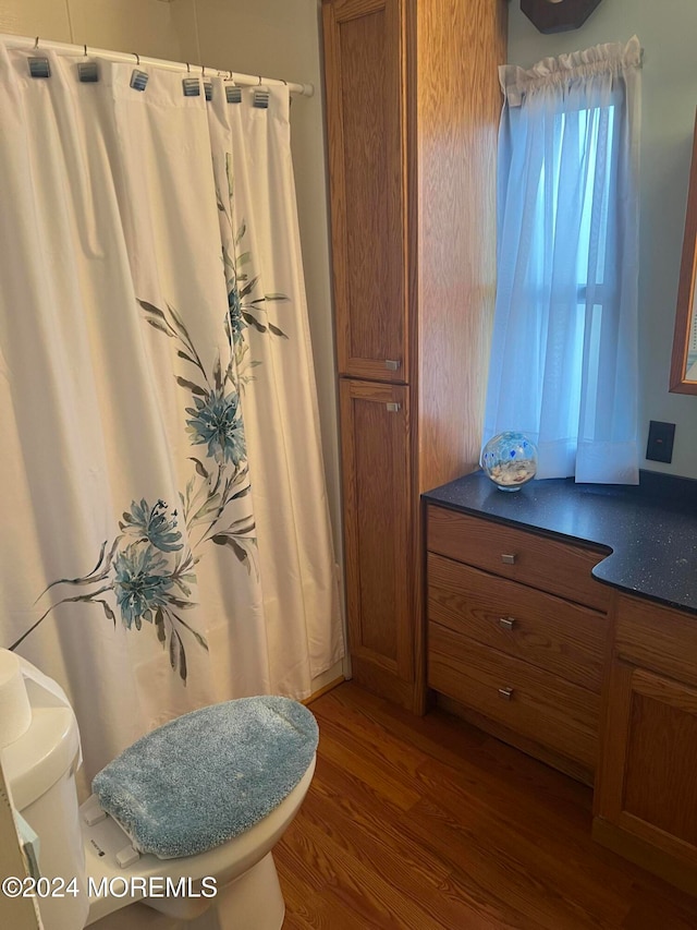 bathroom featuring hardwood / wood-style floors and toilet