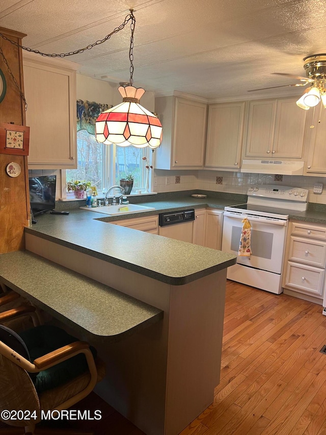 kitchen featuring a textured ceiling, white appliances, ceiling fan, decorative light fixtures, and light hardwood / wood-style floors