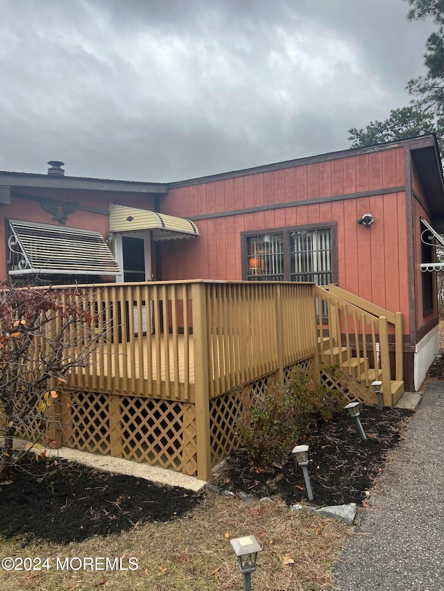 view of side of home featuring a wooden deck