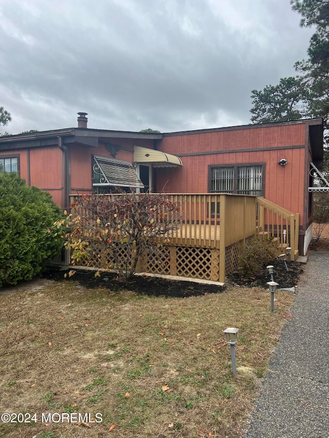 rear view of house featuring a deck