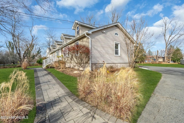 view of home's exterior featuring a yard