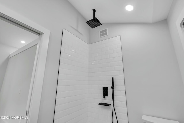 interior details featuring a tile shower